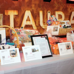 A display of silent auction events at Light the Way.
